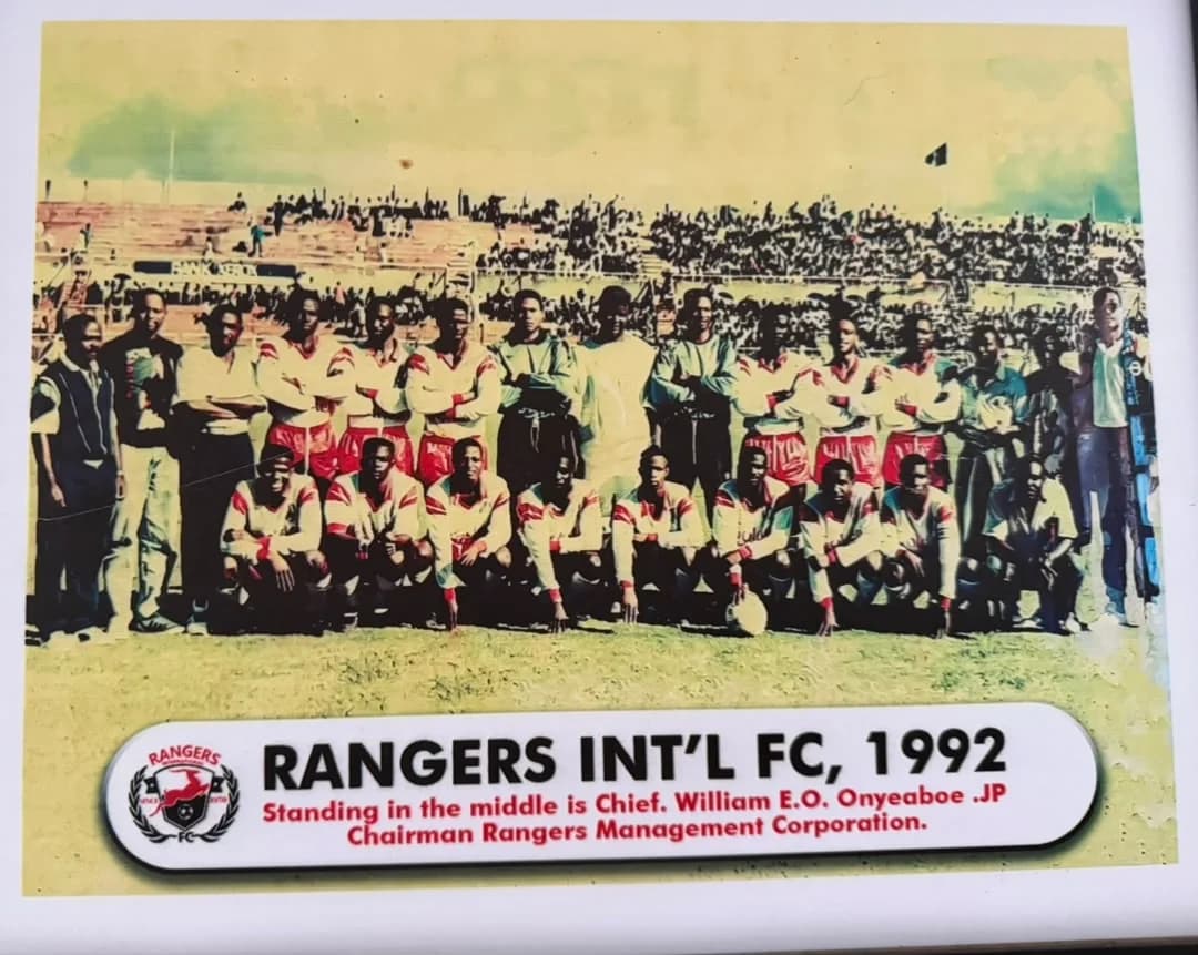 The 1992 Rangers squad and officials lined up on the pitch before a full stadium.